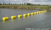 yellow traffic control booms in the river thumbnail